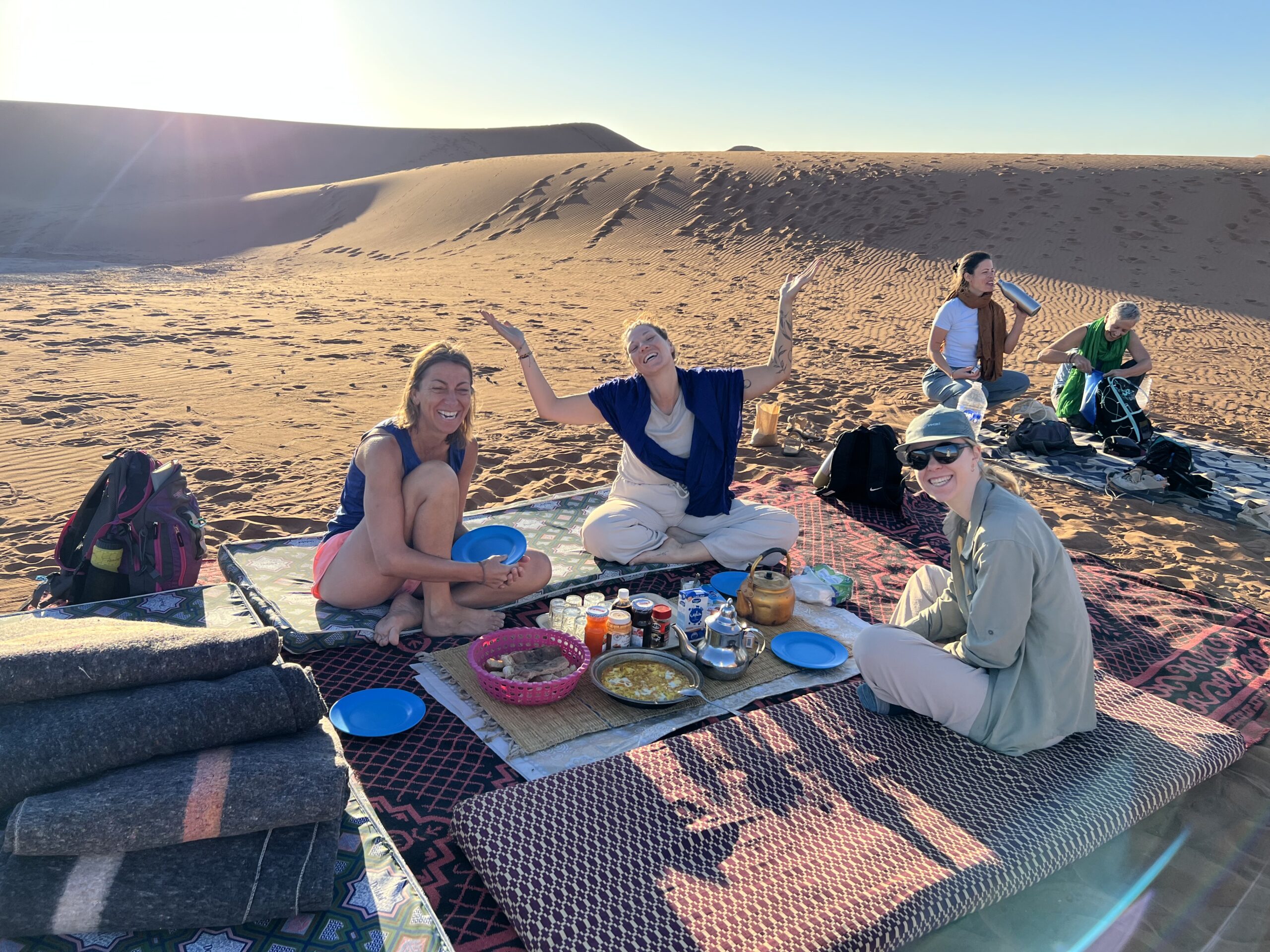 Petit-déjeuner en groupe dans le désert marocain, ambiance conviviale